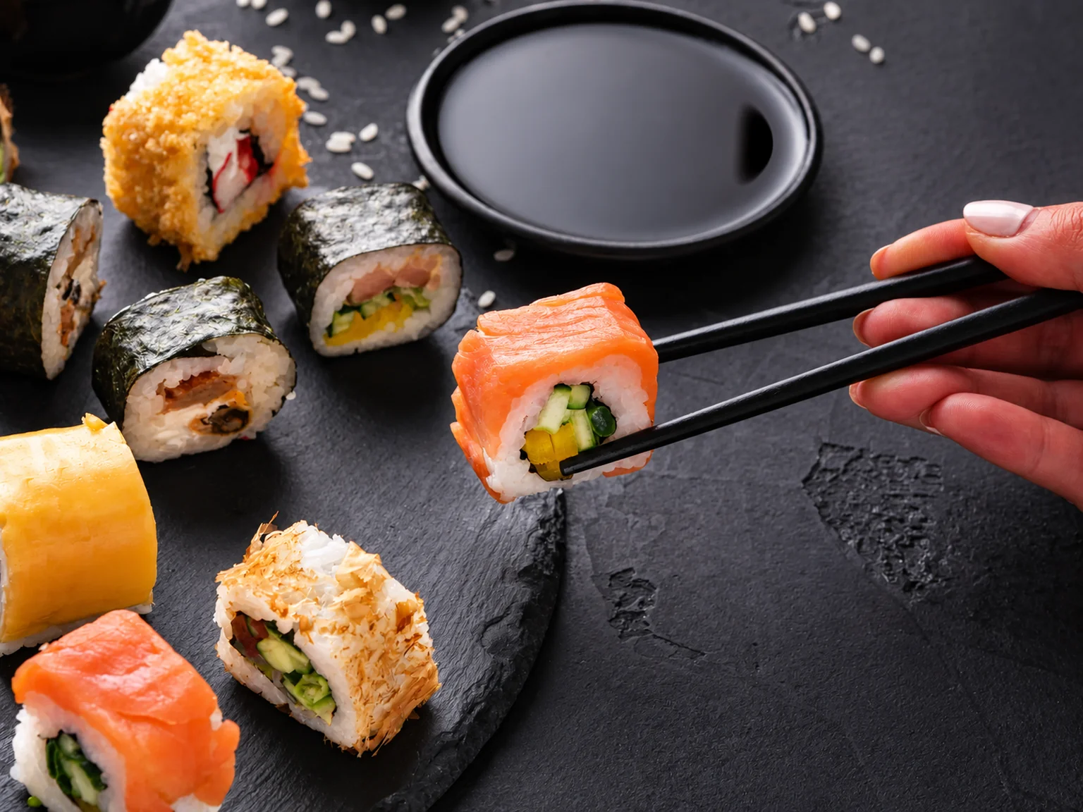 Sushi on a dark surface with chopsticks · illustration